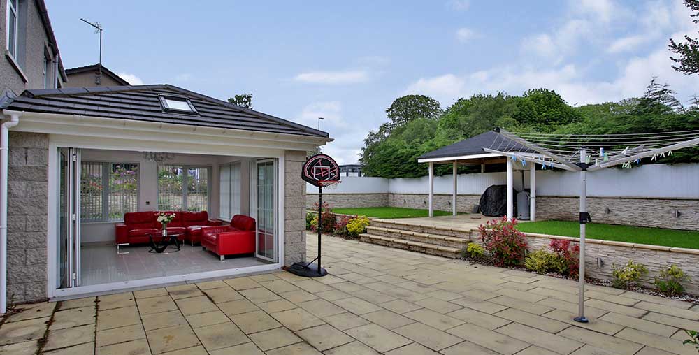 home extension with patio doors leading out to a patio garden area